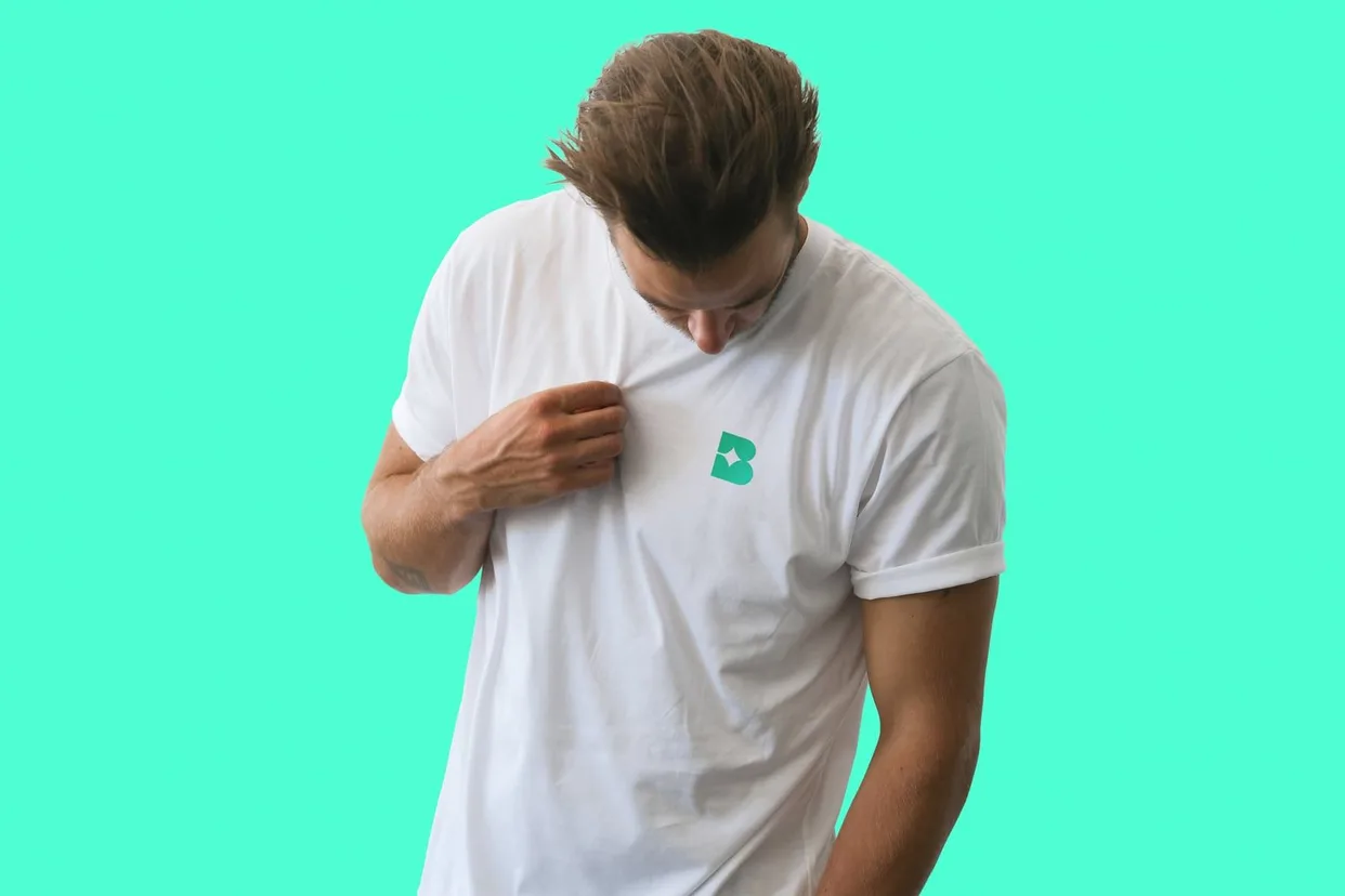 A man in a white tee with the Bublr mark on the chest, against the brand green