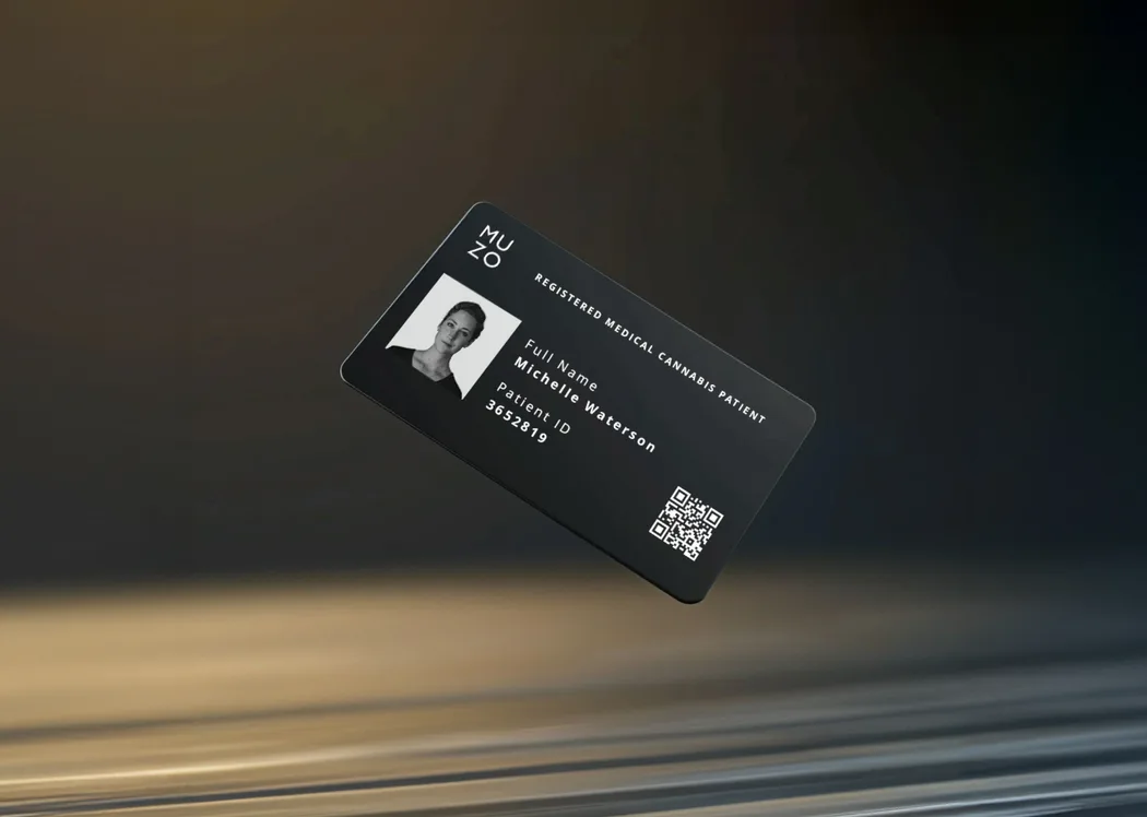 A black MUZO patient card turning in the light, the holder photograph and patient number on the face and a QR code in the corner