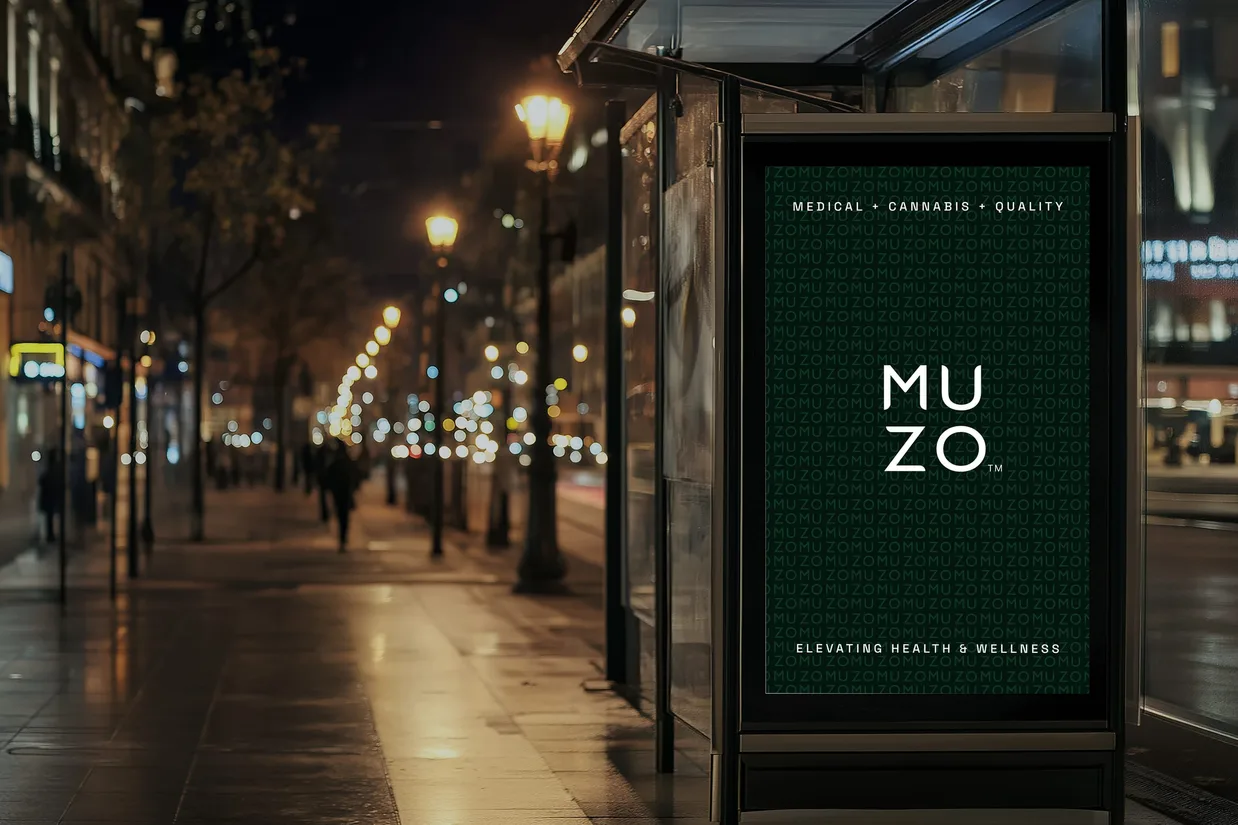 A bus shelter panel on a wet boulevard at night carrying the line Medical, Cannabis, Quality over the MUZO wordmark on a dark green monogram field, and Elevating health and wellness under it