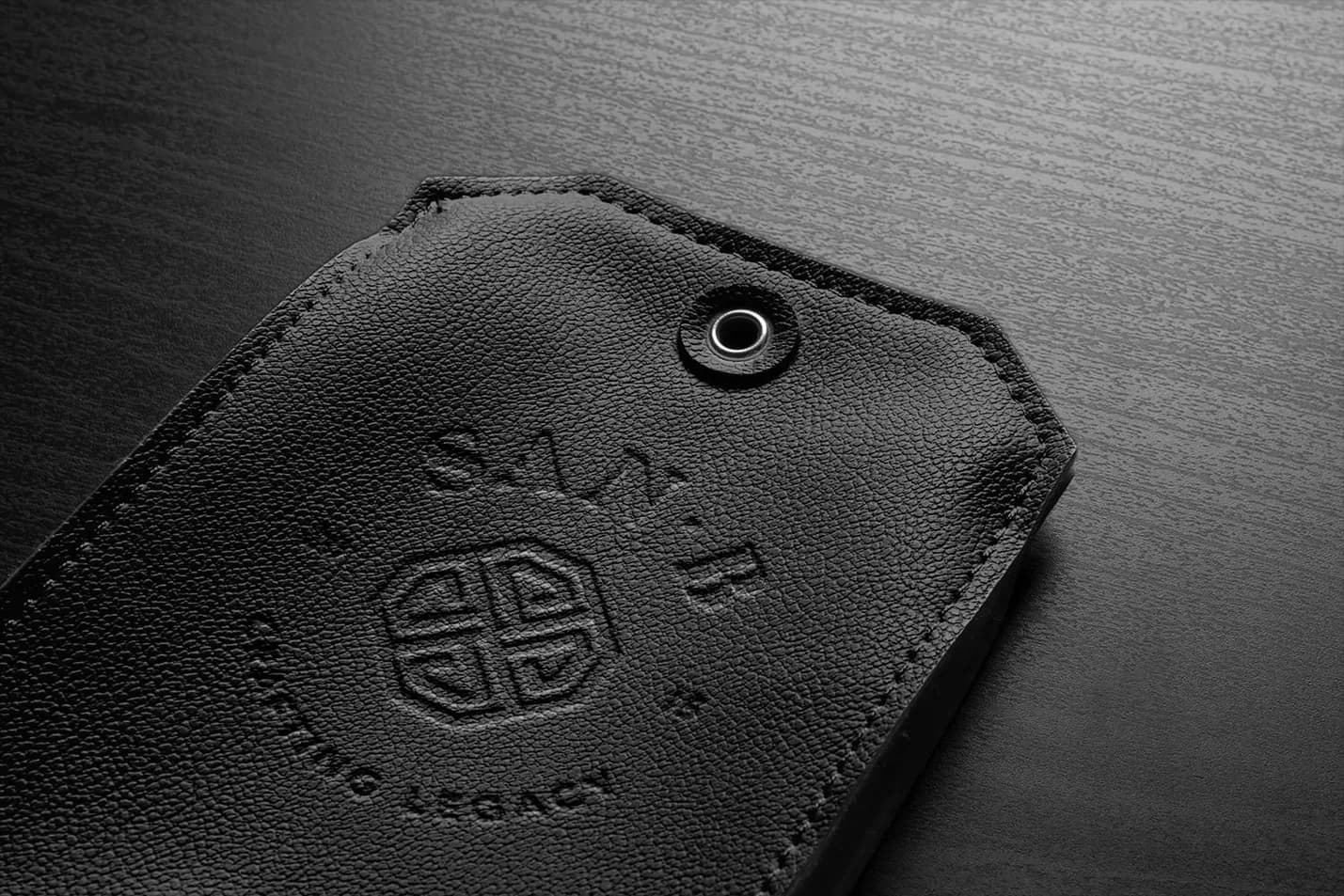 The roundel embossed on a black leather tag