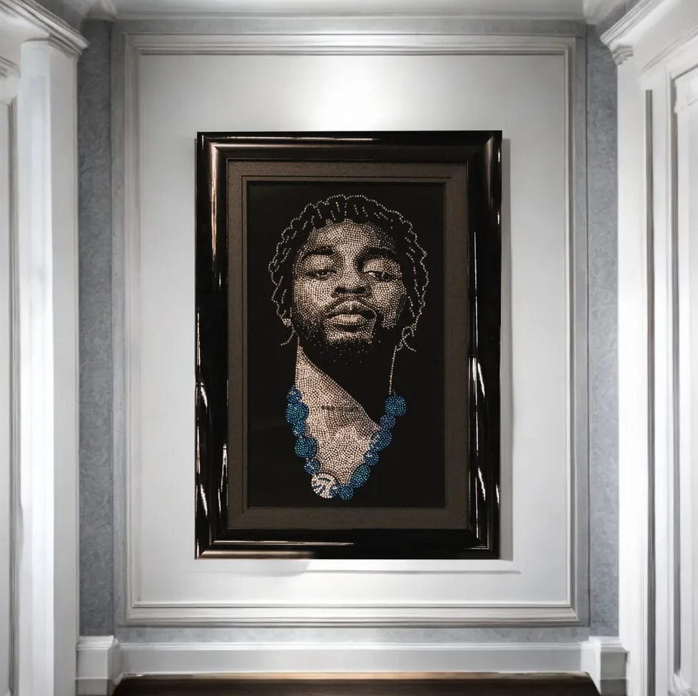 The Omah Lay piece framed in a white panelled hall
