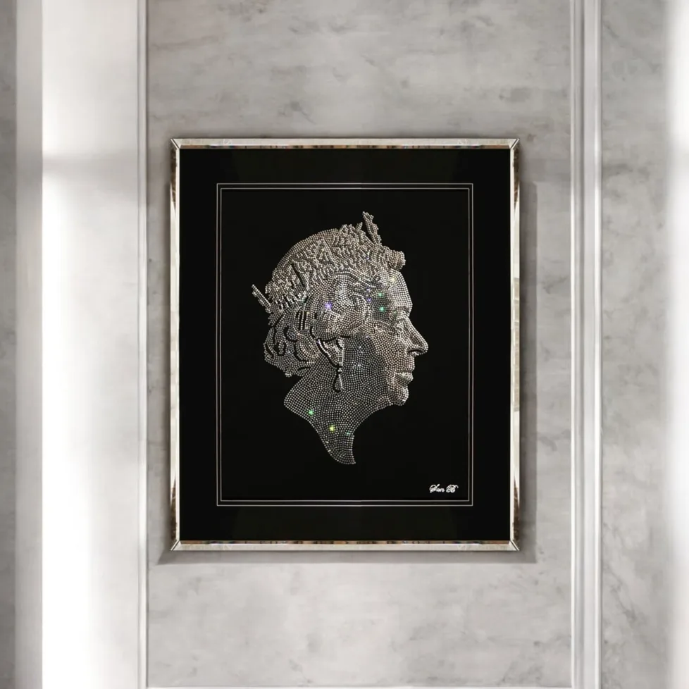 Queen Elizabeth II in profile in crystal, framed on a white wall