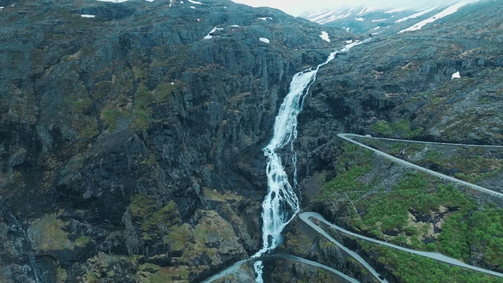 The hairpin road down the mountain, white water beside it