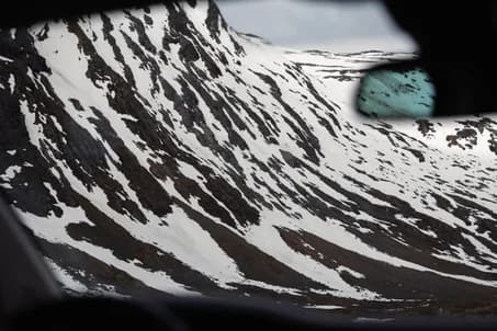 The snow flank through the windscreen on the mountain road