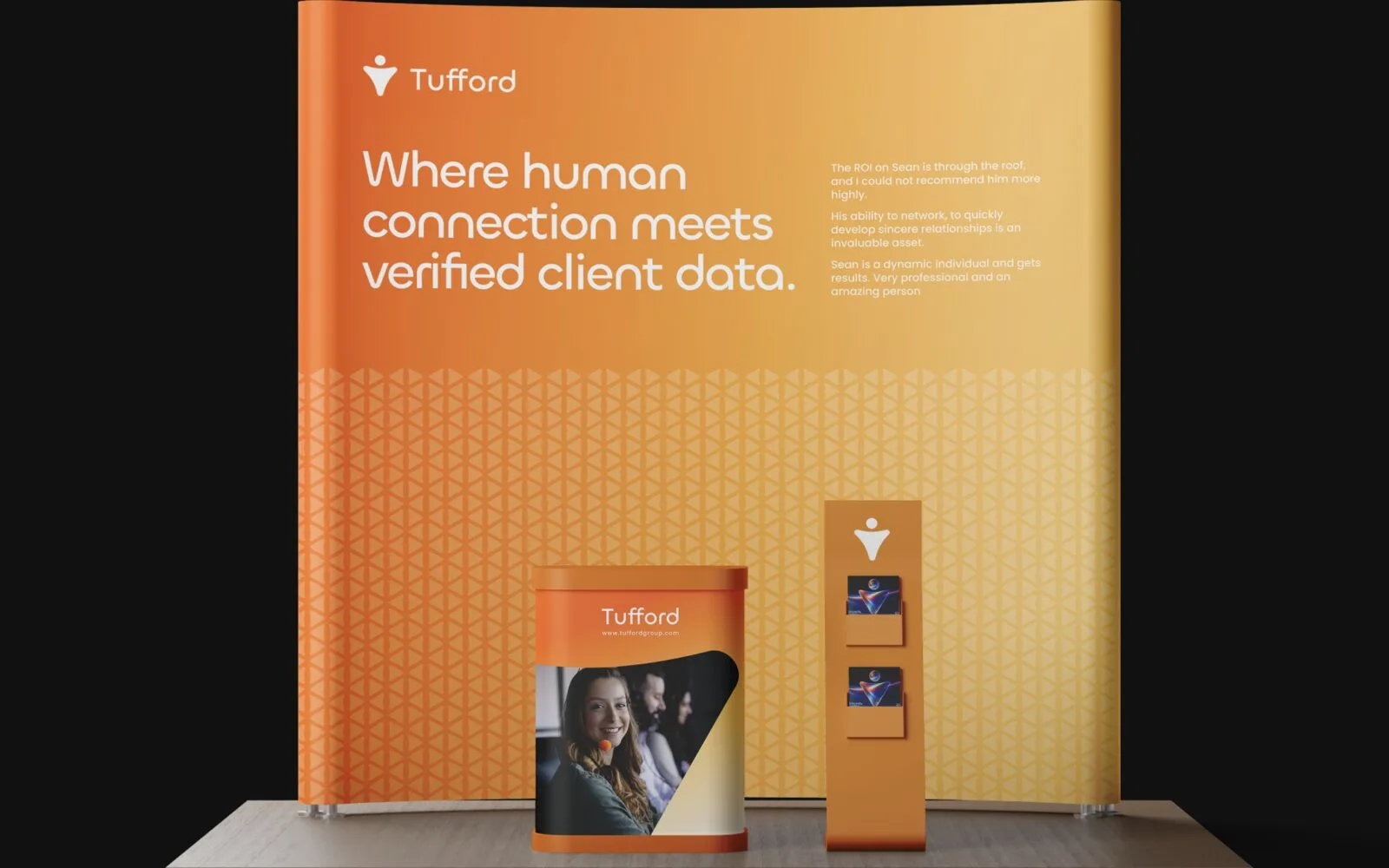 The Tufford exhibition stand, Where human connection meets verified client data across its back wall, a literature tower beside it