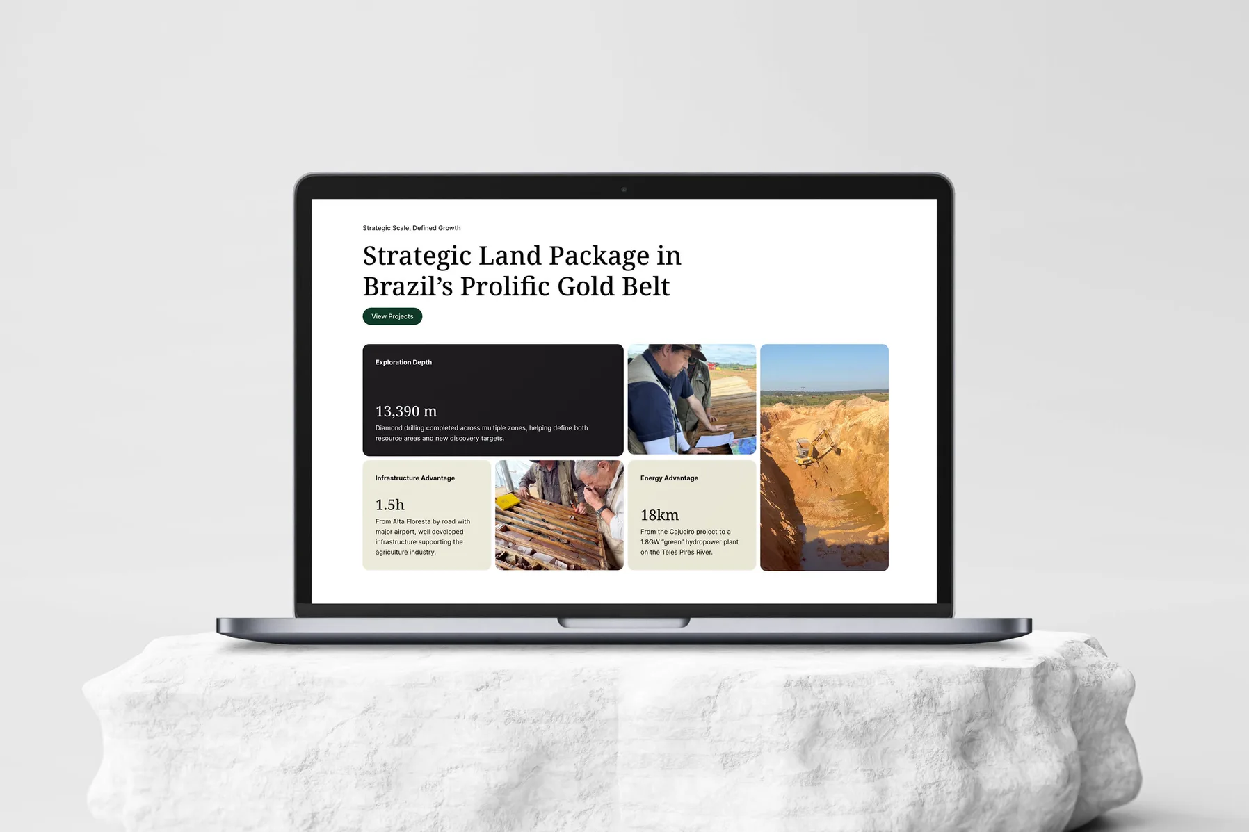 The Altamira Gold home page on a MacBook on a white stone: Strategic Land Package in Brazil's Prolific Gold Belt over a grid of cards