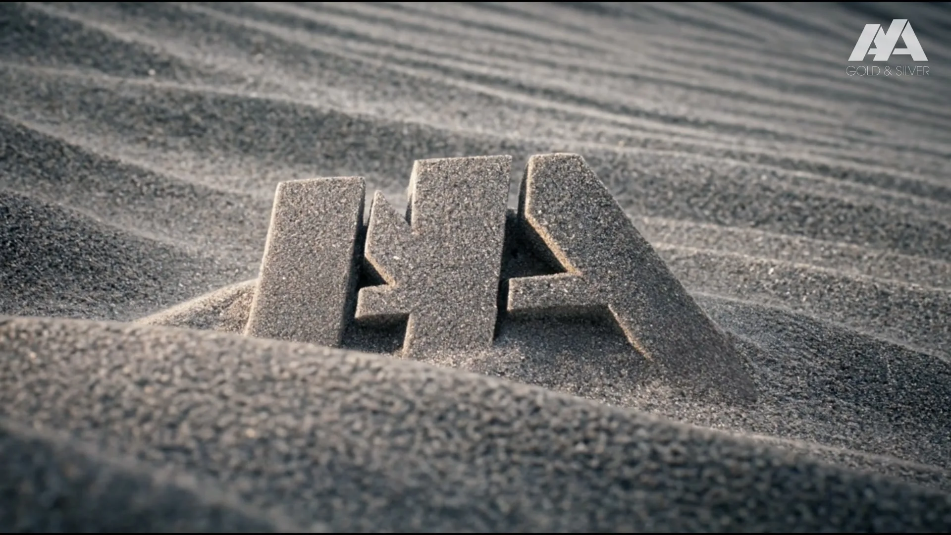 The Aya Gold and Silver mark standing in rippled silver sand: the end card of The Silver Kingdom